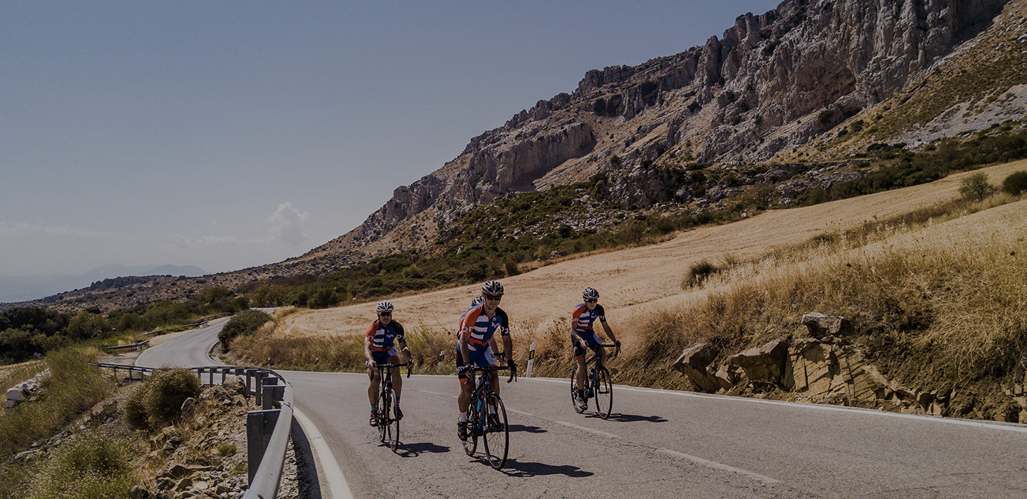 Cyclists climbing a hill for cycling training plans